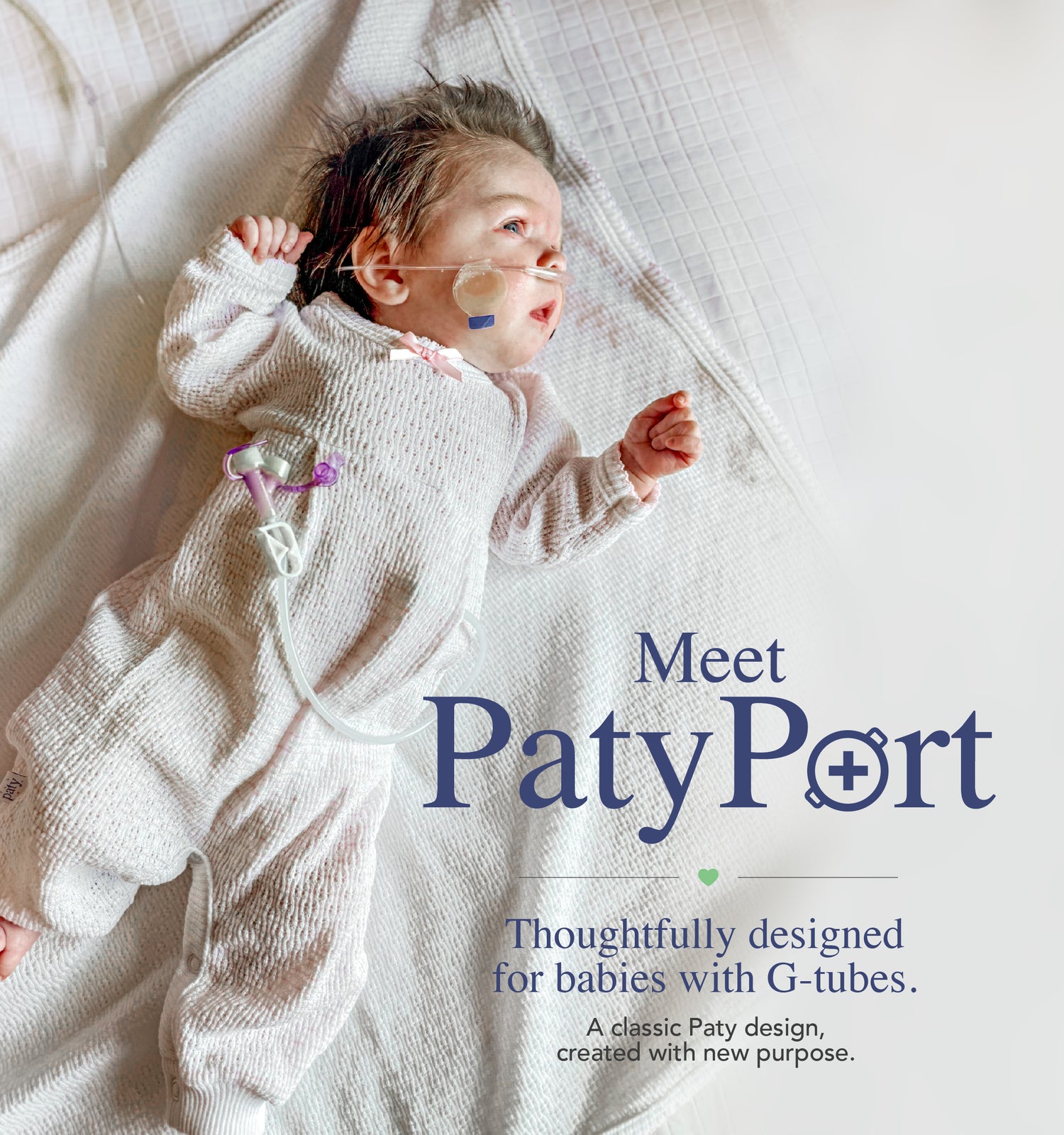 Baby wearing PatyPort G-tube clothing with discreet access for feeding and care